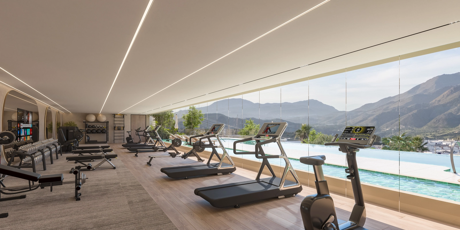 Het ultramoderne fitnesscentrum, volledig uitgerust en met uitzicht op het zwembad en de bergen voor een inspirerende training.