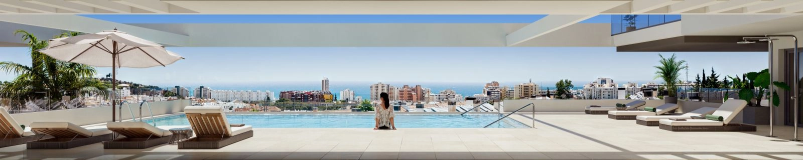 Het overloopzwembad op het dak biedt een perfecte plek om te ontspannen en te genieten van het panoramische uitzicht op zee.