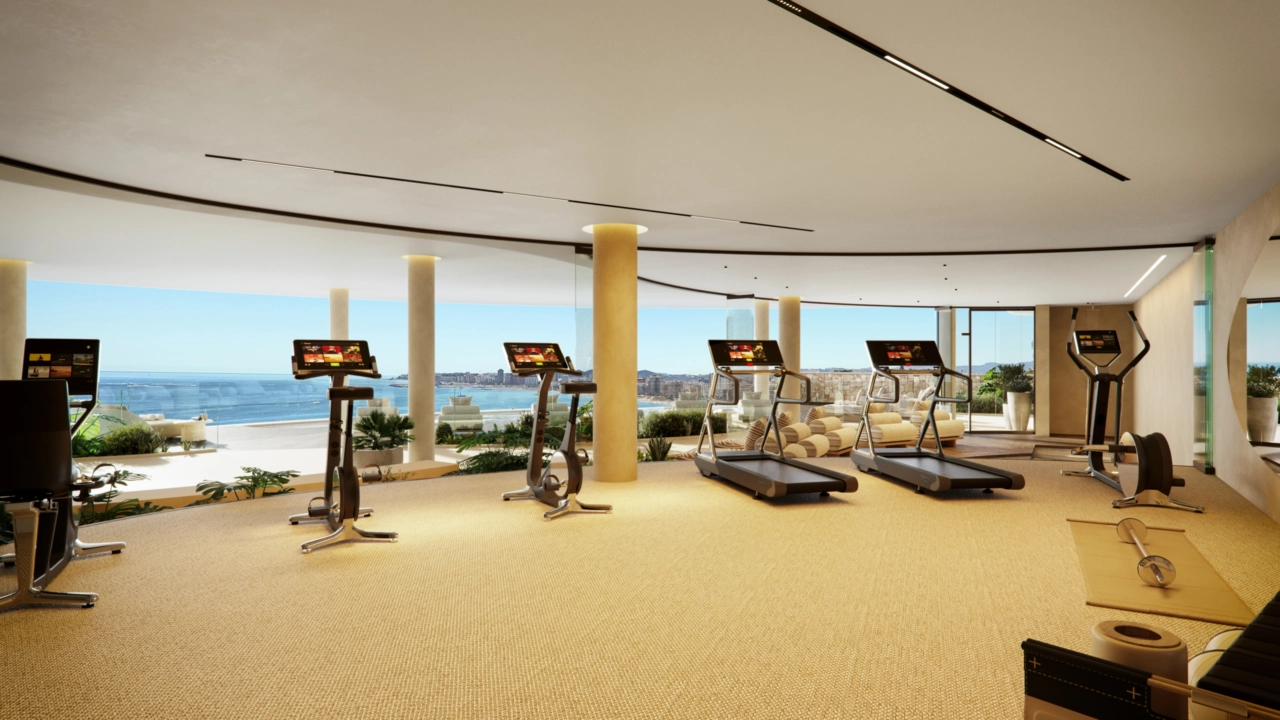 De ultramoderne fitnessruimte, waar u zich kunt richten op uw welzijn, geïnspireerd door een prachtig uitzicht op zee.