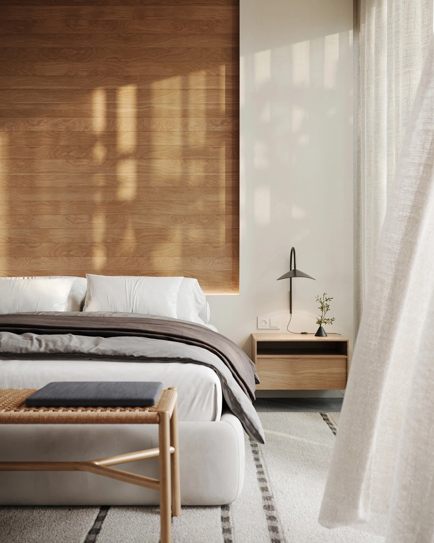 De hoofdslaapkamer is een rustgevend toevluchtsoord, met natuurlijke materialen en grote ramen om het ochtendlicht binnen te laten.